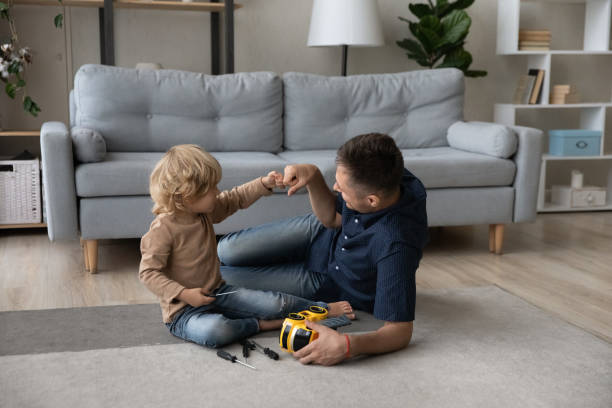 istock Happy cute small son bumping fists with caring millennial father. 1405631750
