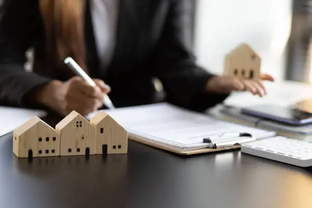 Photo of Real estate contract signing concept. Businesswoman signing a contract to legally for the purchase, mortgage and rental of real estate.