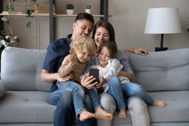 istock Happy bonding two generations family using cellphone at home. 1405632298