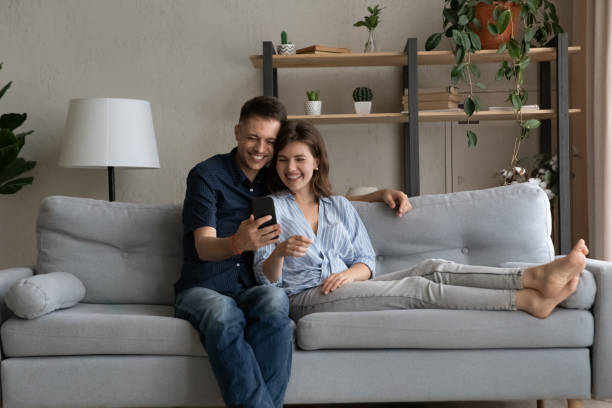 istock Happy bonding young family couple using smartphone. 1405632305