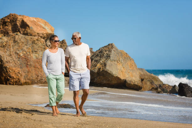 istock Senior African American couple walking on beach 1405632622