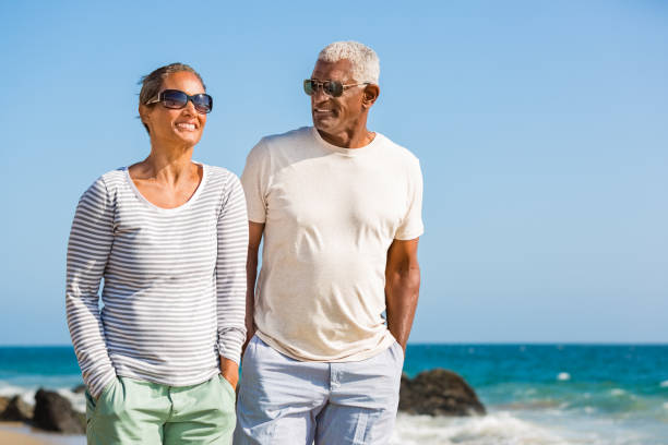 istock Senior African American couple walking on beach 1405632628