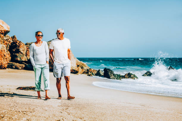 istock Senior African American couple walking on beach 1405632668