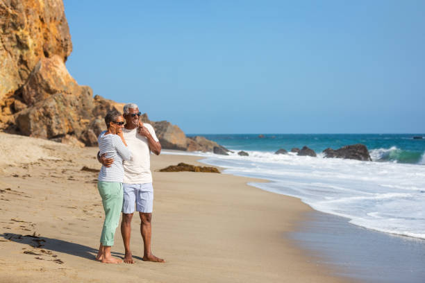 istock Senior African American couple embracing on beach 1405632721