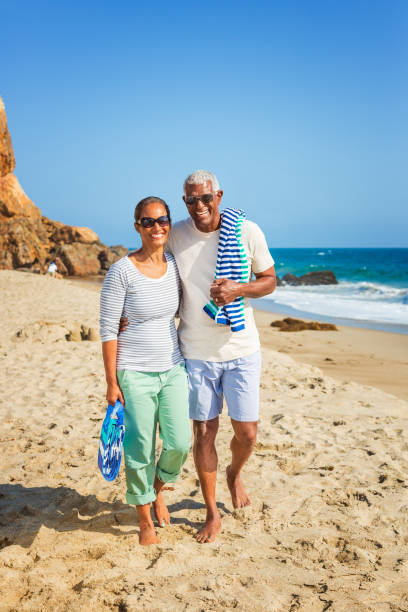 istock Senior African American couple walking on beach 1405632834