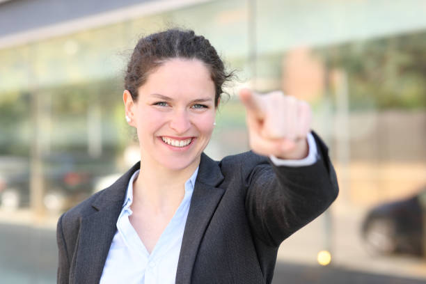 istock Happy executive pointing at camera in the street 1405633413