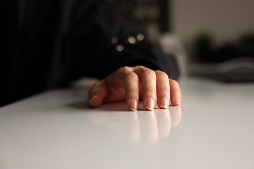 Woman hand on table