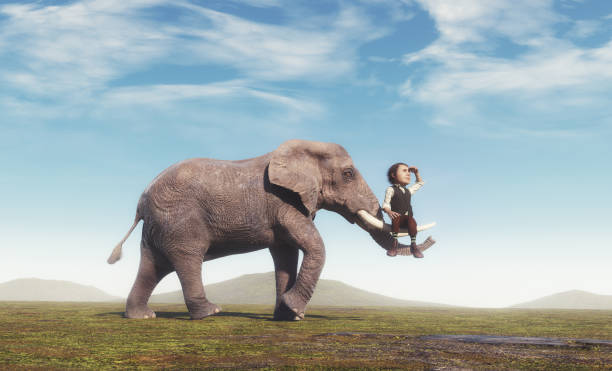istock Elephant carries a small old man. 1405634808