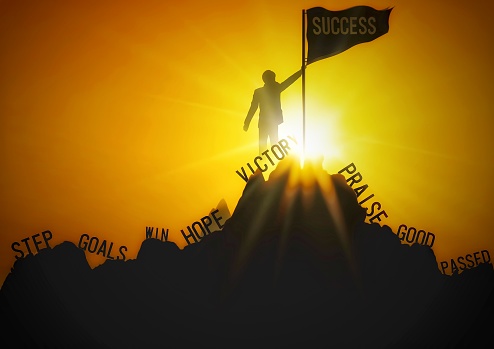 Silhouette illustration of a businessman standing on the mountaintop with the concept of success