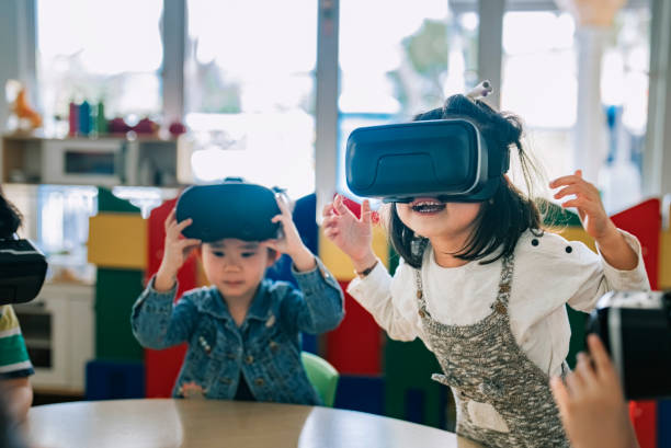 istock exciting Asian chinese preschool students enjoy having fun time with VR google in classroom 1405636247