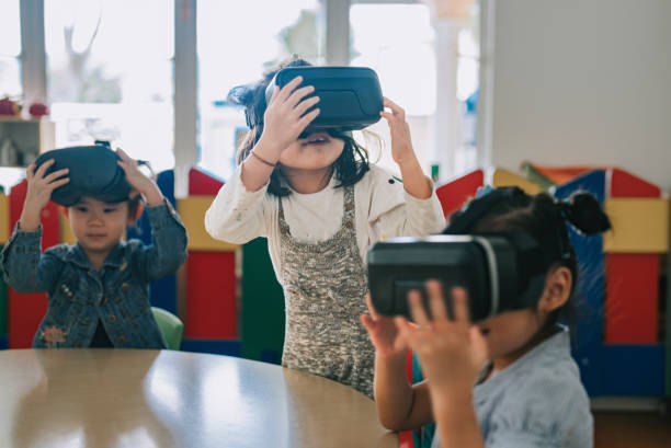 istock exciting Asian chinese preschool students enjoy having fun time with VR google in classroom 1405636251