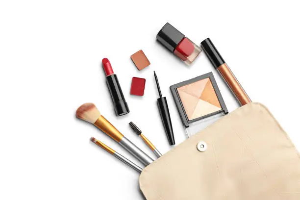 Make up products. Lipstick, powder, shadows with cosmetic bag. Image with copy space. White background with clipping path