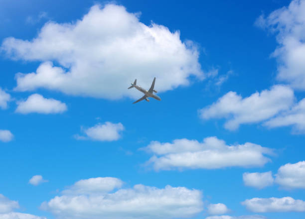 istock passenger plane in the sky with clouds- 1405636561
