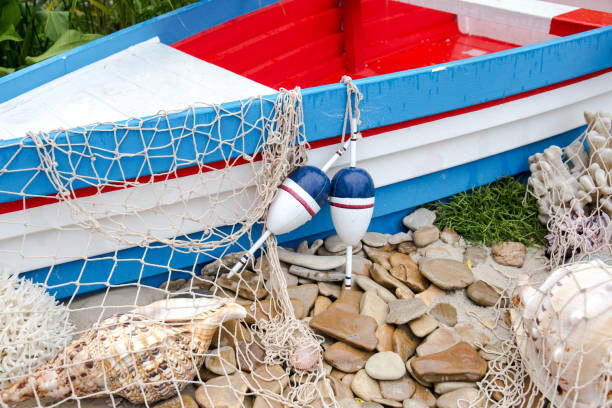 istock Fishing nets, floats, corals and shells on the sandy shore. 1405638186