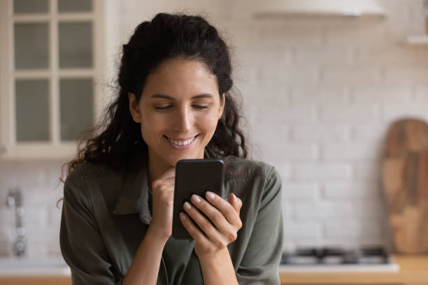 istock Happy young latina woman using smartphone applications. 1405640928