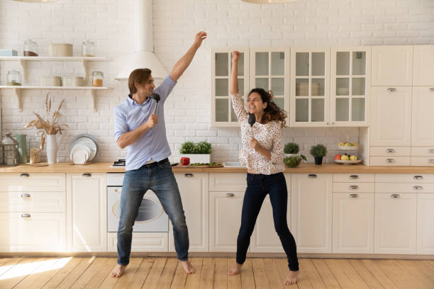 istock Overjoyed young family couple having fun in kitchen. 1405640961