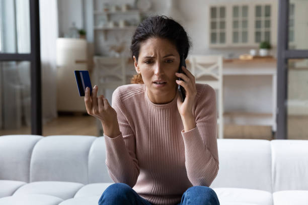 worried young hispanic woman call bank unable pay by card - kvinna telefonbedragare bildbanksfoton och bilder