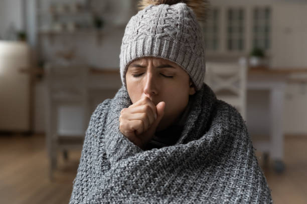 istock Ill lady under cap plaid feeling fever cough breath hard 1405643471