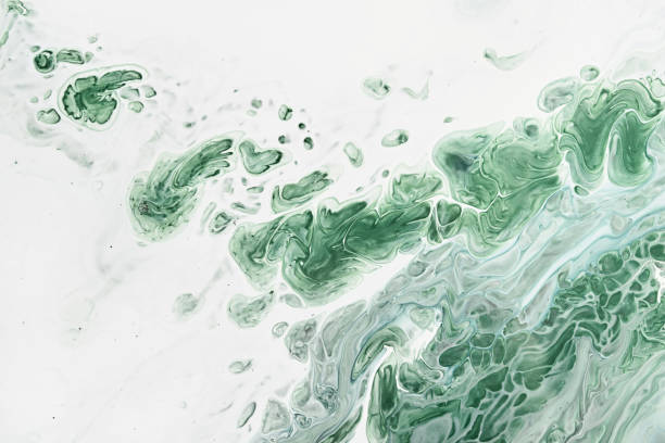 istock Fluid Art acrylic paints. Abstract mixing green waves on white background. Liquid flows splashes. Marble effect background or texture 1405643692