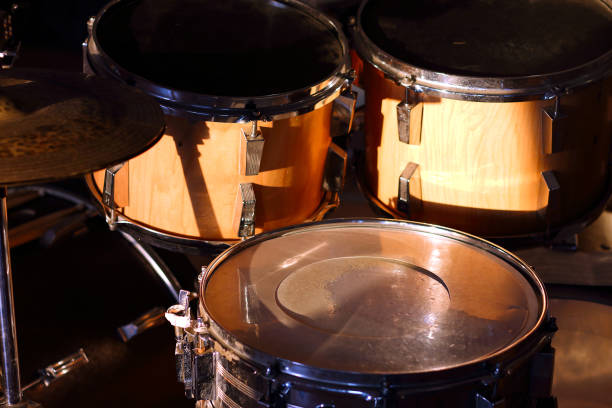 istock Drum set illuminated by the rays of the setting sun in a music studio. Closeup. 1405645173