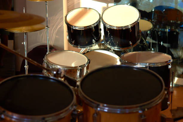 istock Drum set illuminated by the rays of the setting sun in a music studio. Closeup. 1405645334