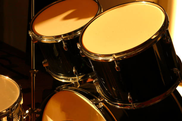 istock Drum set illuminated by the rays of the setting sun in a music studio. Closeup. 1405645860