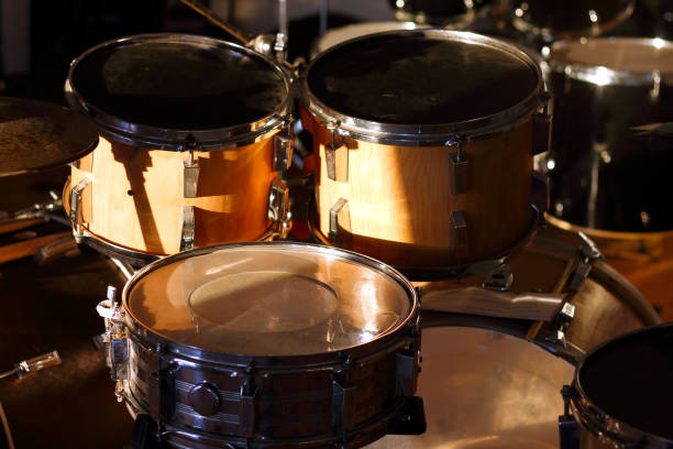 istock Drum set illuminated by the rays of the setting sun in a music studio. Closeup. 1405645923