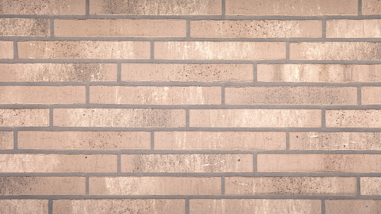 Background of brown brick wall close - up. Horizontal format. Architectural background.