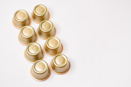 Coffee capsules on the white background with copy space, espresso capsules