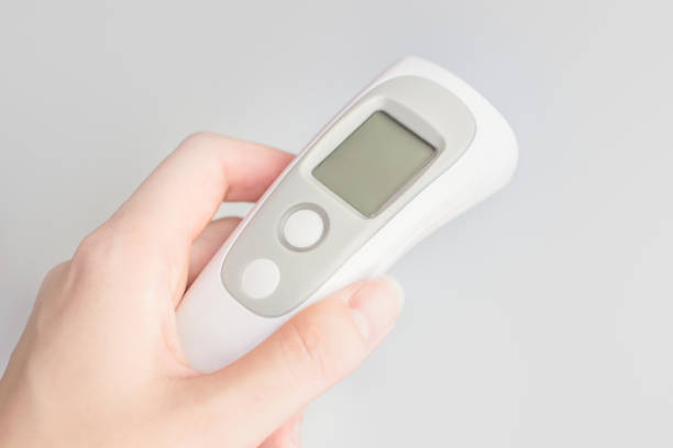 istock Female hand holding a modern infrared thermometer 1405648394