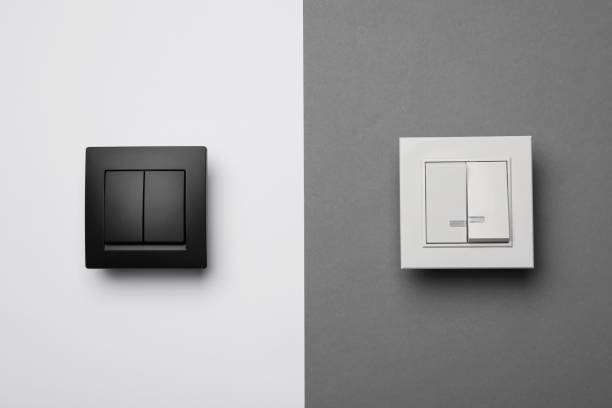istock White and black light switches on color background 1405648443