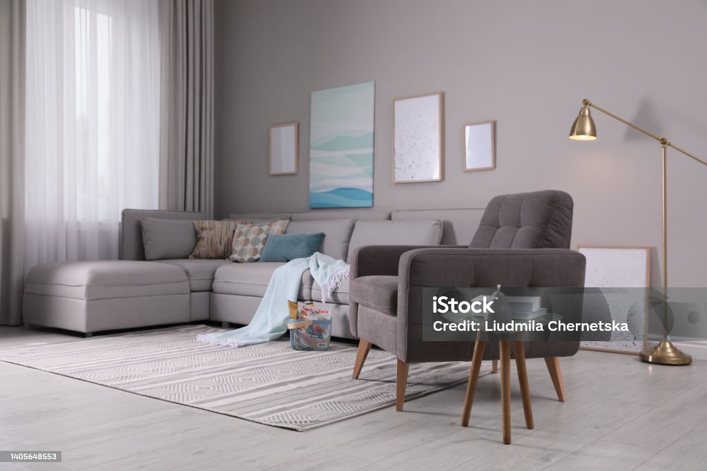 Stylish living room interior with comfortable armchair and sofa Living Room Stock Photo