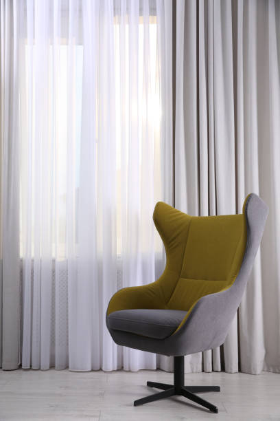 istock Comfortable armchair near window indoors. Interior design 1405648602