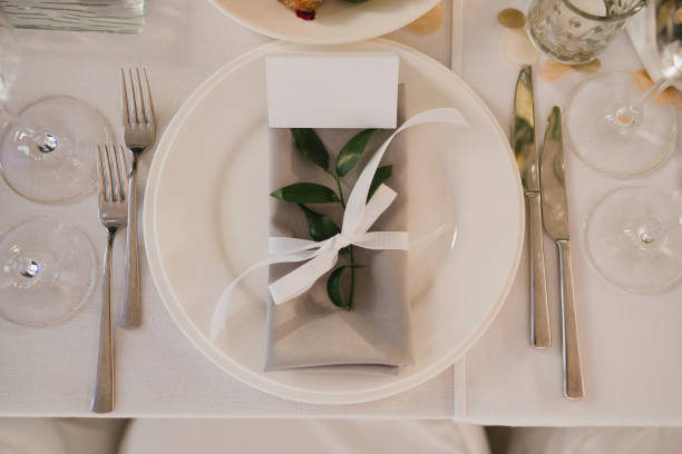 istock Table setting at the wedding reception. Floral compositions with beautiful flowers and greenery, candles, laying and plates on a decorated table. 1405648623