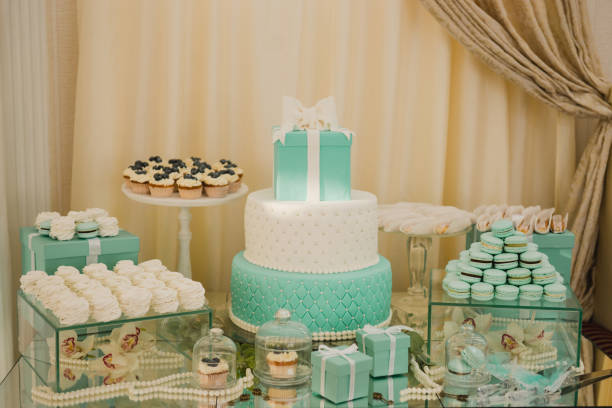 Decorated with flower compositions and candles. Sweet food, dessert, buffet, catering table, restaurant.