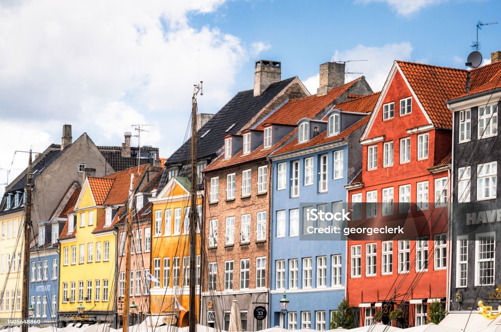 Colourful traditional buildings along Nyhavn Harbour in Copenhagen Old fashioned buildings alongside Nyhavn Harbour, one of Copenhagen's most famous locations. Copenhagen Stock Photo