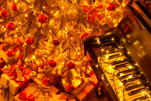istock Bright Christmas tree, many presents under it near piano 1405649601