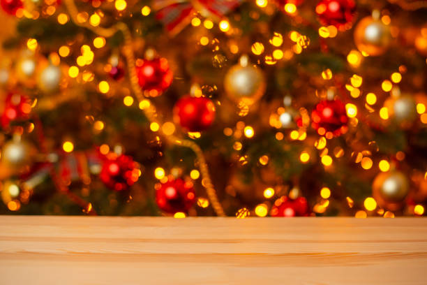 istock Wooden table and decorated Christmas tree in the background 1405649617