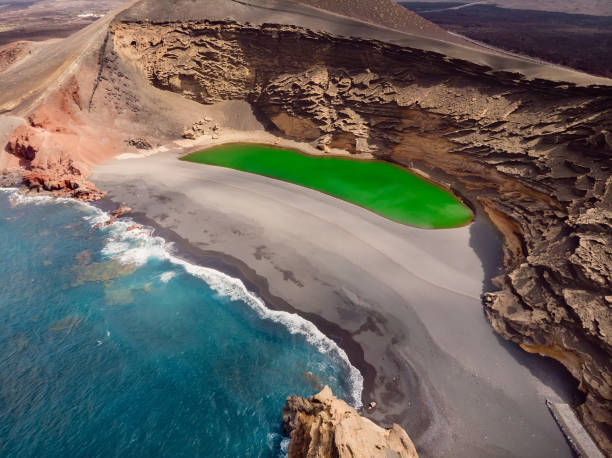 paysage pittoresque avec cratère volcanique avec lac vert à el golfo, lanzarote, espagne. vue aérienne - lanzarote canary islands volcano green photos et images de collection