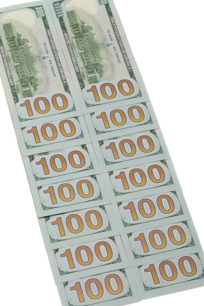 istock One Hundred Dollar Bills on white background. 1405650249