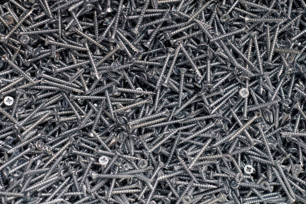 istock Bunch of galvanized stainless screws with flat countersink head, hardware background, silver screws 1405651342