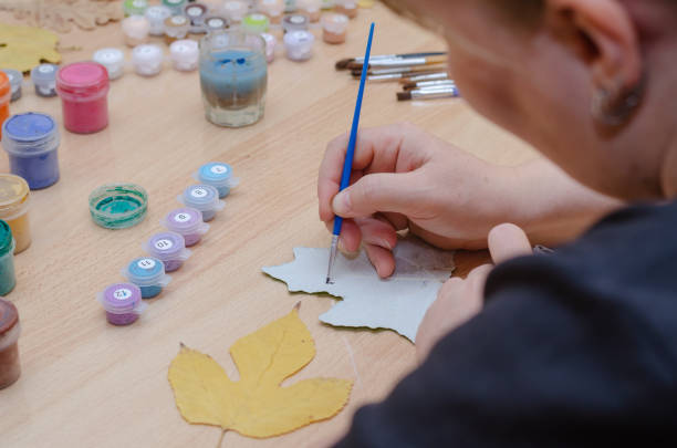 istock The artist draws on dry fallen leaves. 1405654047