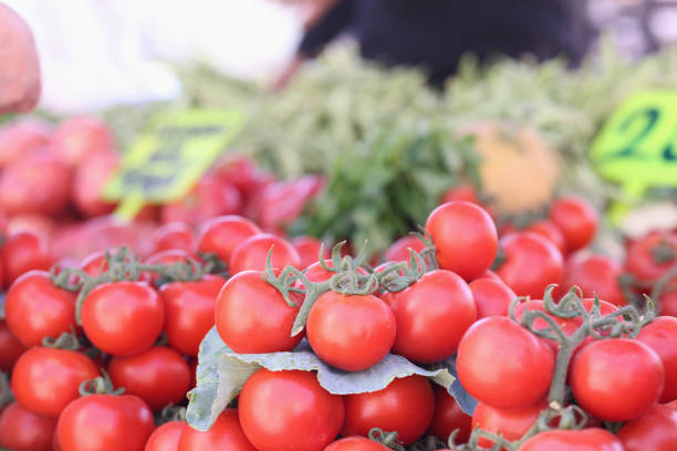 Close-up of tomatoes in the vegetable section of a supermarket.