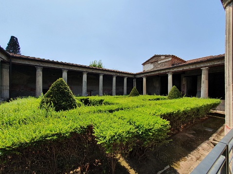 Ancient garden in the middle of courtyard in Pompei Italy