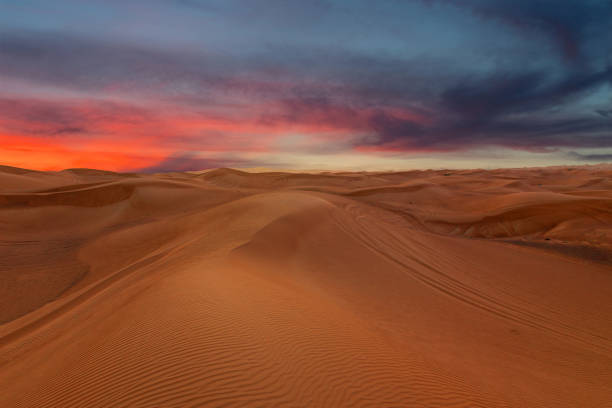 istock Sunset sky sand desert landscape, with dunes and red dramatic sunset picturesque view 1405656600