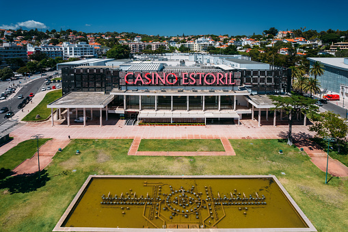 Estoril, Portugal - June 28, 2022: Aerial view from Estoril Garden and the iconic Casino Estoril at the end of the garden. Casino Estoril is the 5th largest casino in Europe