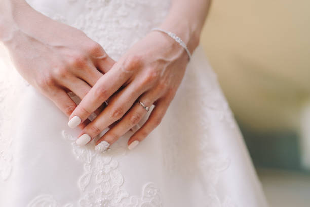 istock Closeup of engagement ring on bride's finger. 1405660896