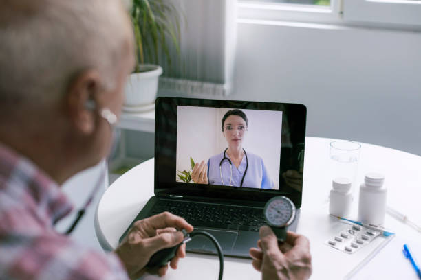 istock Senior man consulting with his doctor online 1405663692