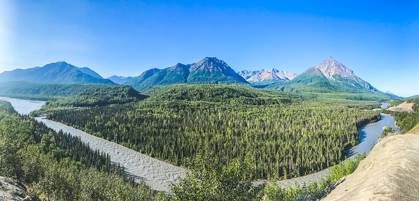 The scenic vista point shows Alaska in its Spring season. Snow runoff has muddied the Matanuska river. The Chugach mountains rise up in beauty and splendor making this vista point a stopping point for many.