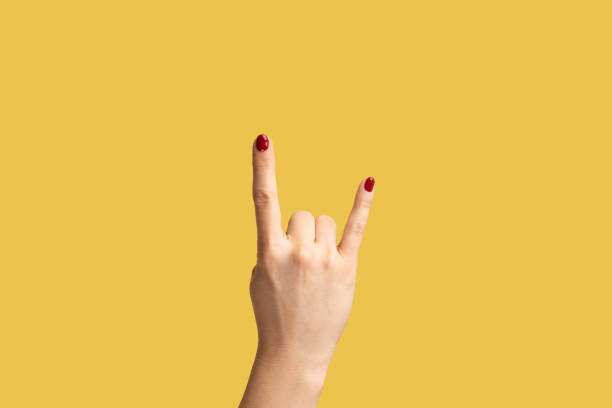 Closeup woman hand showing rock sign, rock and roll sign hand gesture. stock photo